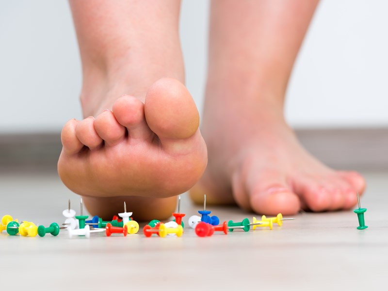 Someone about to step on pins in bare feet