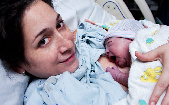 Mother with newborn child on chest