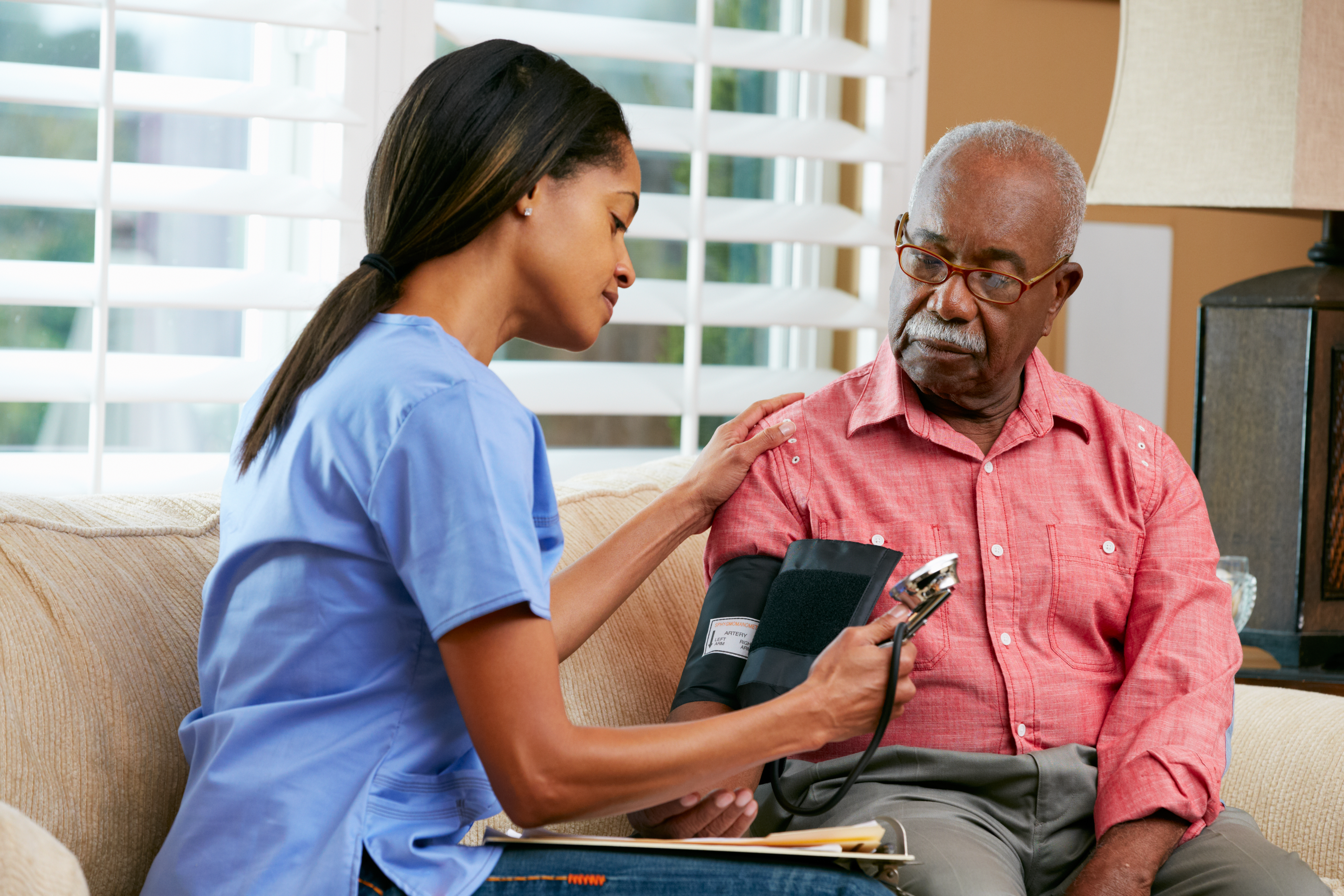 A nurse taking a man's blood pressure