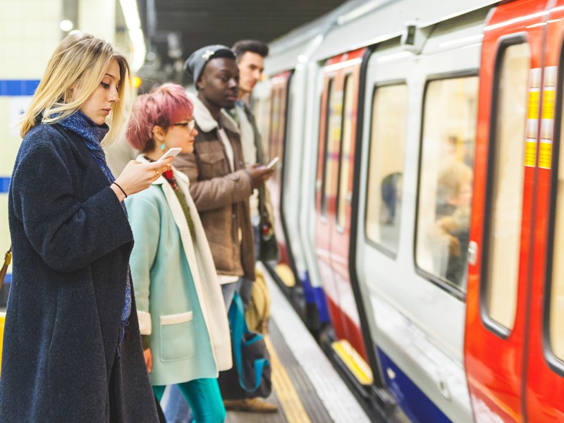 Young woman using a smartphone in the subway