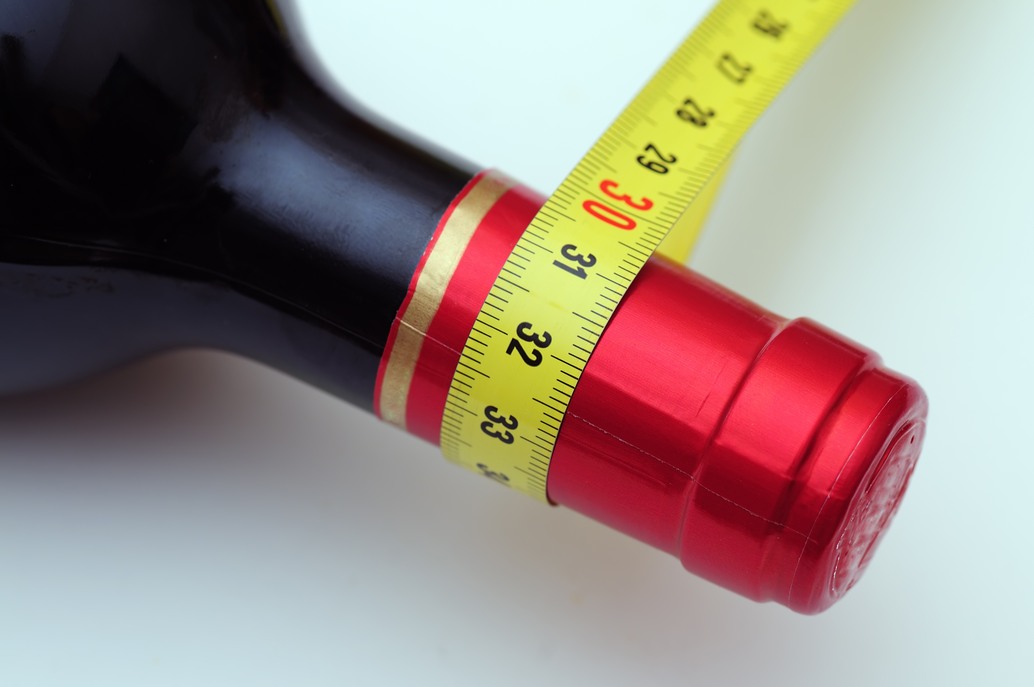 Wine bottle with tape measure around it