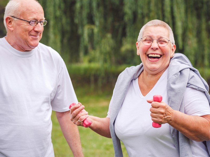 Older and woman exercising outdoors