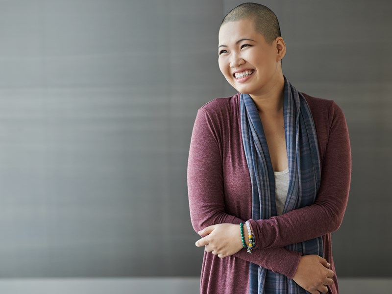 woman with shaved head smiling